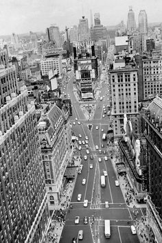 an aerial view of a city with tall buildings and lots of traffic on the street