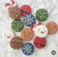 decorated christmas cookies arranged on a marble surface