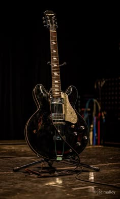 an electric guitar sitting on top of a stand