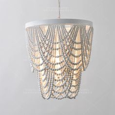 a chandelier with beads hanging from the ceiling