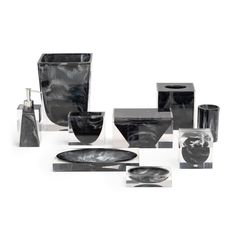 an assortment of black and white vases, dishes, and soap dispensers