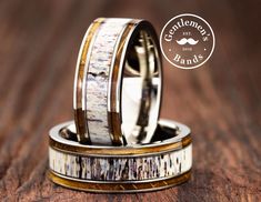 two wedding bands with deer antler and bone inlays on top of each other