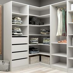 a white closet filled with lots of clothes