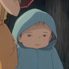 a young child in the rain with an umbrella