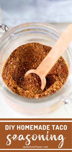 homemade taco seasoning in a glass jar with a wooden spoon on the side