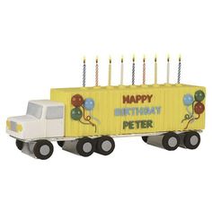 a toy truck with candles in the shape of a birthday cake on it's back