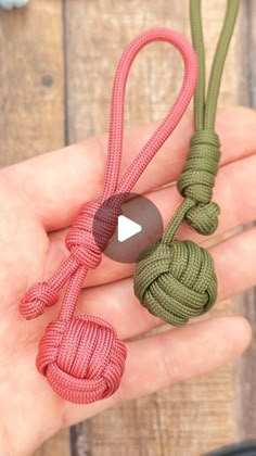 someone is holding two different ropes in their hand, one green and the other red