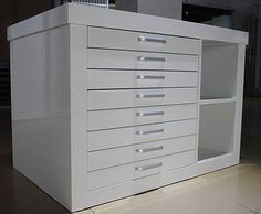 a white cabinet with drawers on the floor