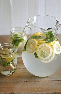 a pitcher filled with lemon and mint water