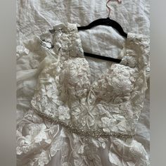 a white dress is laying on a bed