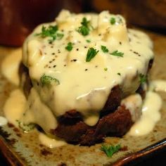 a close up of a plate of food with meat and gravy on it