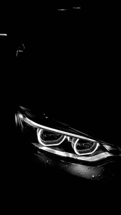 the front lights of a car in black and white