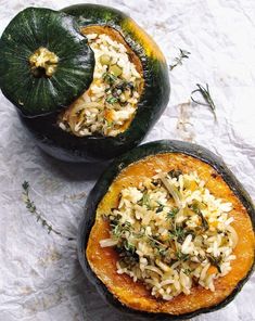 two squash halves with rice and herbs in them