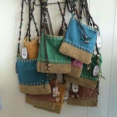 several purses are hanging on the wall