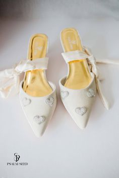 white wedding shoes with hearts on them