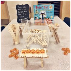 a table topped with lots of wooden sticks