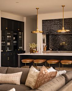 a living room filled with furniture and lots of counter top space next to a bar