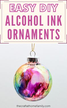 an ornament with the words easy diy alcohol ink ornaments on it and a pink