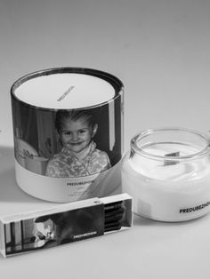 a candle and photo are sitting next to each other