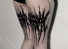 a woman's legs with black paint on them