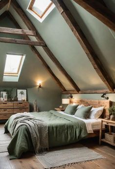 an attic bedroom with wooden beams and green bedding in the center, along with two nightstands on either side of the bed