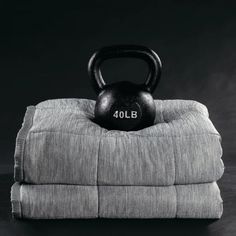 a black and white photo of a kettle sitting on top of some folded towels with the number 40lb written on it