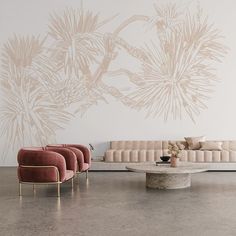 a living room with two couches and a coffee table in front of a wall mural