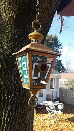 a lamp hanging from the side of a tree