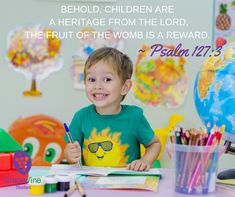 a little boy sitting at a table with some markers and pencils in front of him