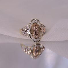 14k Oval Shaped Virgin Mary Ring / Blessed Mother Ring / Diamond Cut Religious Rings / Mother Mary Gold Ring / Gift For Her FEATURES @ Made to Order @ Materials: 14K  @ Avg Weight: 2.67g @ Gemstone: None @ Handmade in the USA SIZING If you need assistance with your ring size, just hit the "Message CherVenue" button and we will get back you within a few hours. RETURNS & EXCHANGES  I gladly accept returns, exchanges, and cancellations Contact me within: 7 days of delivery Ship items back within: 1 Gabi Demartino Wedding Ring, Princess Mary Ring, Luxury Vintage Rings For Memorial, Luxury Vintage Rings For Memorials, Vintage Gold Ring With Halo, Oval Ring With Hallmark For Anniversary, Oval Hallmarked Ring For Gift, Oval Hallmarked Ring As Gift, Gold Oval Ring With Hallmark