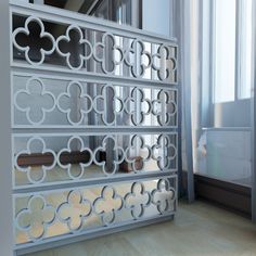 the room divider is made out of metal and has an intricate design on it