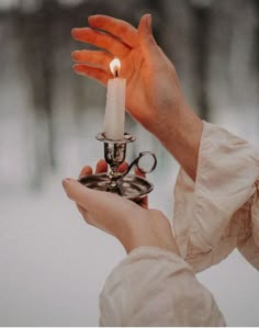 a person holding a candle in their hand