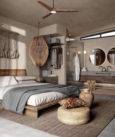 a bedroom with a bed, dressers and mirrors in it's center area