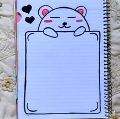 an open notebook with a drawing of a cat in the pocket and hearts on it