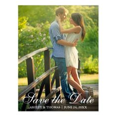 save the date photo magnets with an image of two people standing on a bridge