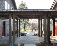 an outdoor covered walkway leading to two buildings