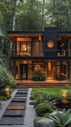 a modern house in the woods surrounded by greenery