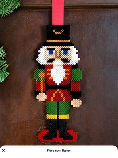 a christmas ornament made out of legos is hanging on a door handle