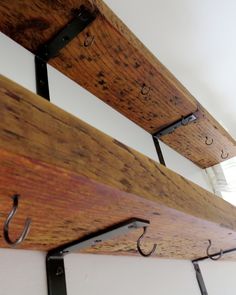 two wooden boards with hooks hanging from them