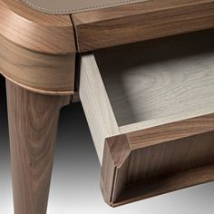 a close up of a wooden table with drawers on each side and one drawer open