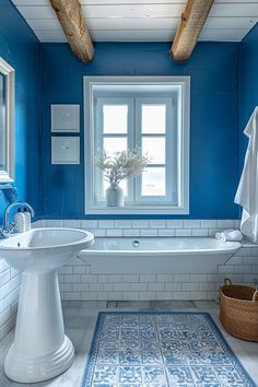 a bathroom with blue walls and white fixtures, including a bathtub in the center