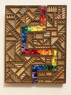 a piece of art that is made out of wood and has different colored blocks on it