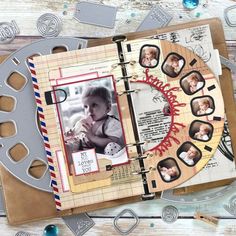 an open scrapbook with photos on it and some other items around it, including scissors