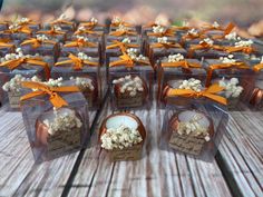 small clear boxes filled with popcorn sitting on top of a wooden table