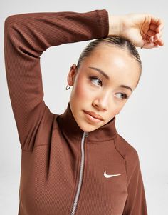 Add sports-inspired style to your off-duty rotation with this women's Trend Rib Full Zip Track Top from Nike. In a Cacao Wow colourway, this full zip top is made from a soft and stretchy cotton-poly knit fabric for a textured feel and comfy layering. It has a slightly cropped hem, raglan sleeves and a stand-up collar for custom coverage. Signed off with a contrasting Swoosh to the chest. Machine washable. | Our model is 5'4" and wears a size small. Nike Trends, Chest Machine, Sign Off, Jd Sports, Women Trends, Off Duty, Zip Top, Sport Fashion, Raglan Sleeve