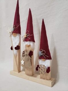 three gnomes made out of wood and fabric