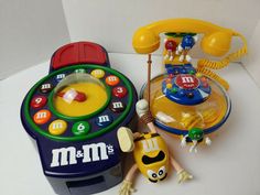 a toy phone and other toys sitting on a table top next to eachother