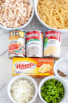 the ingredients for this pasta dish are laid out in bowls