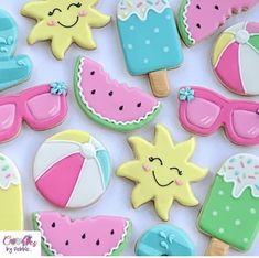 decorated cookies are arranged in the shape of sun, watermelon and umbrellas