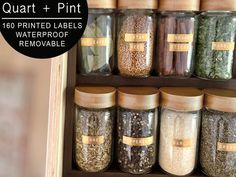 jars filled with different types of herbs and spices on shelves next to each other, labeled quart + pint